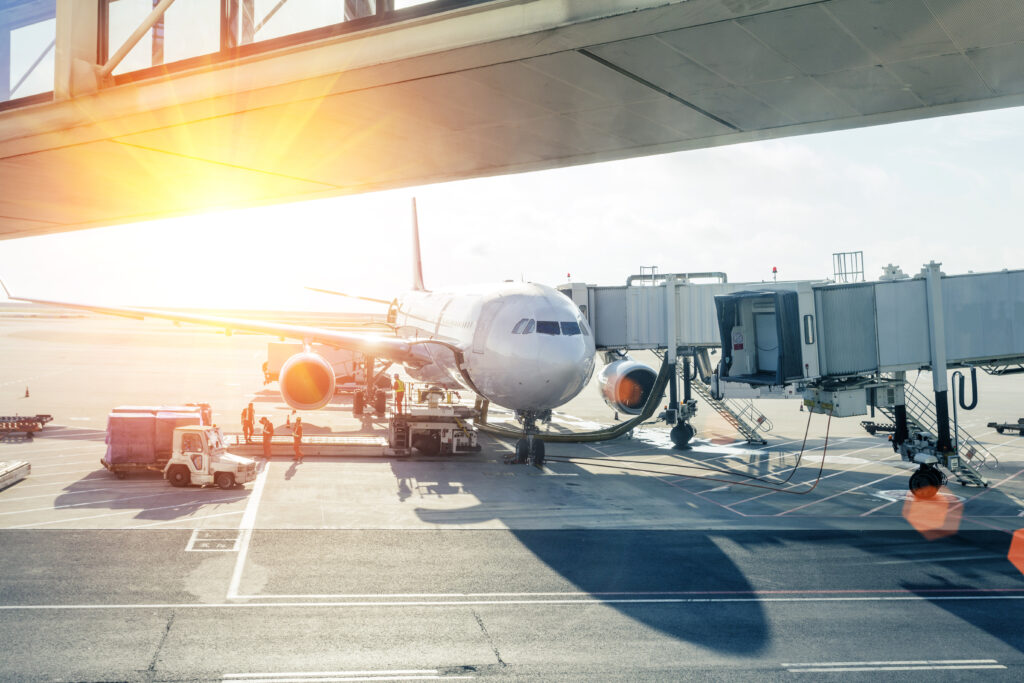 Airplane Loading In Airport At Sunset
